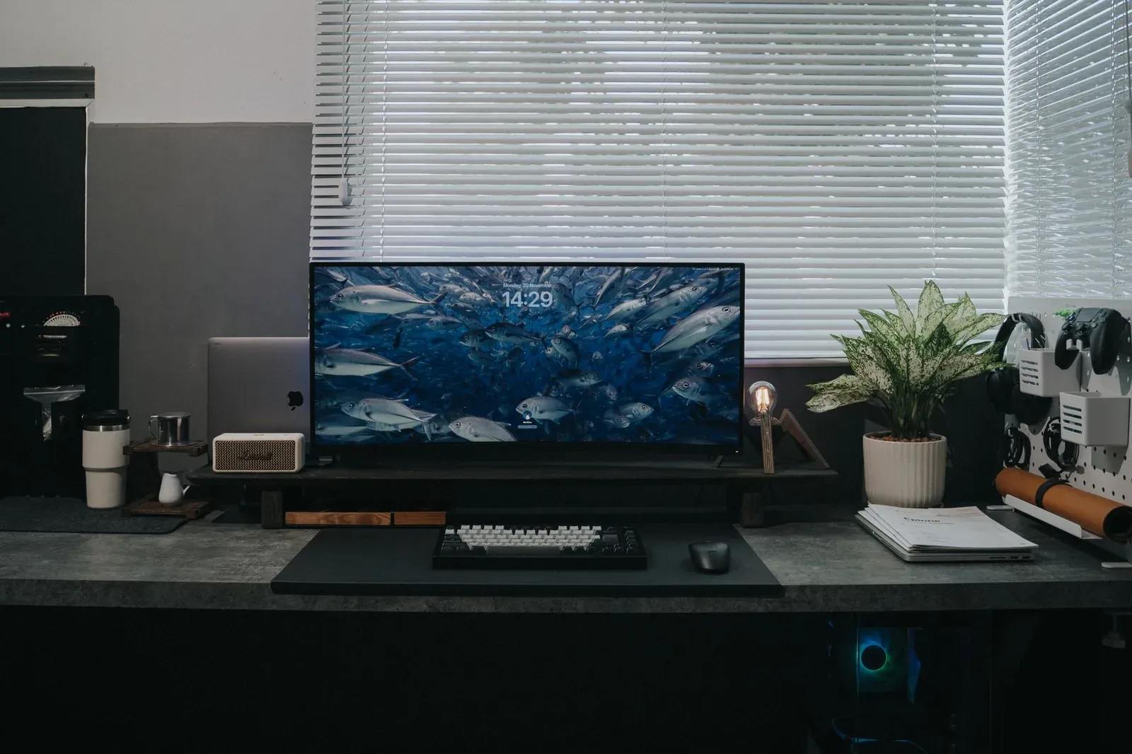 A sleek office desk featuring a computer setup, coffee maker, and plant decor, perfect for productivity.