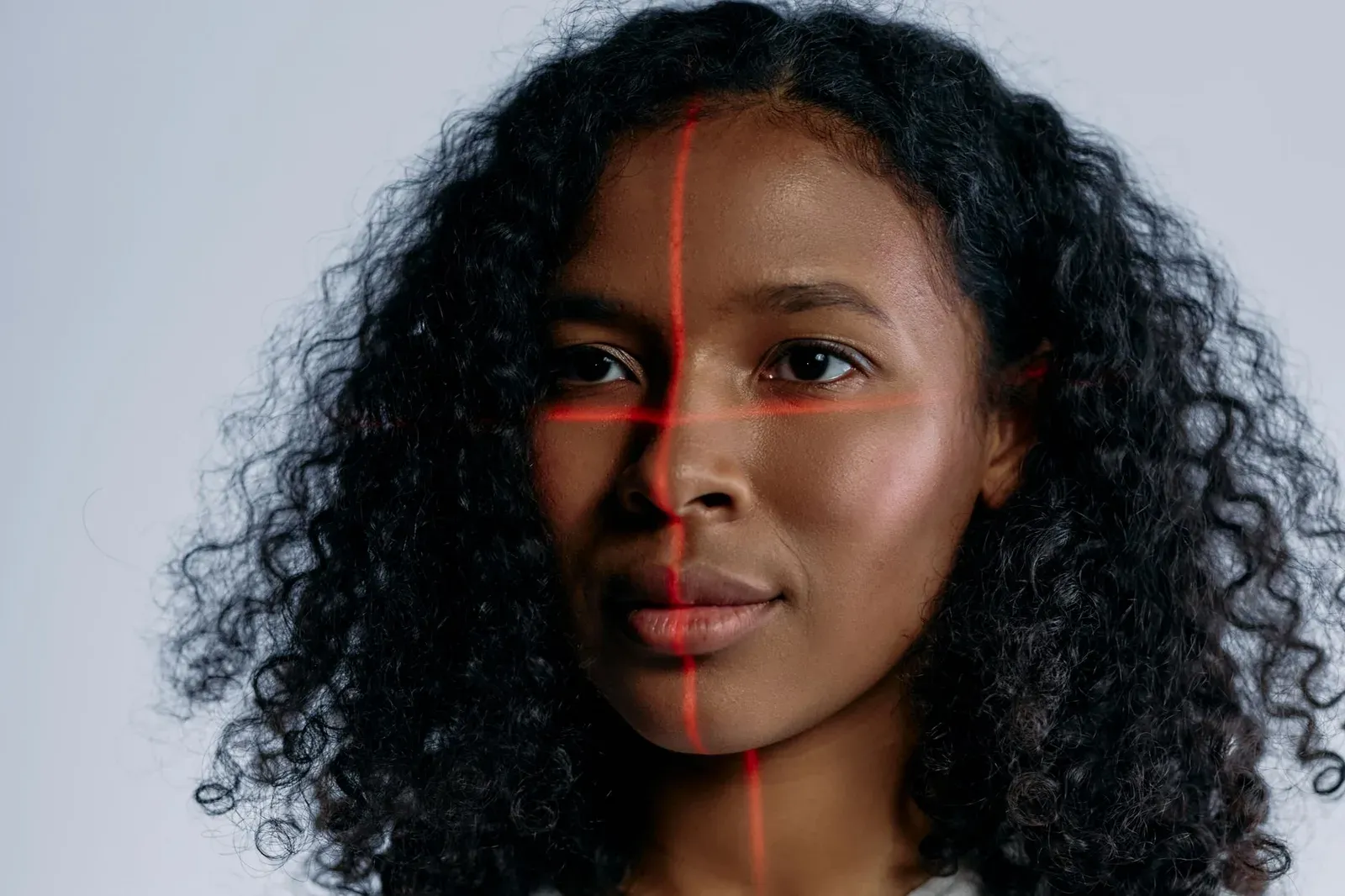 A futuristic portrait of a woman with laser scanning lines on her face, representing advanced technology.