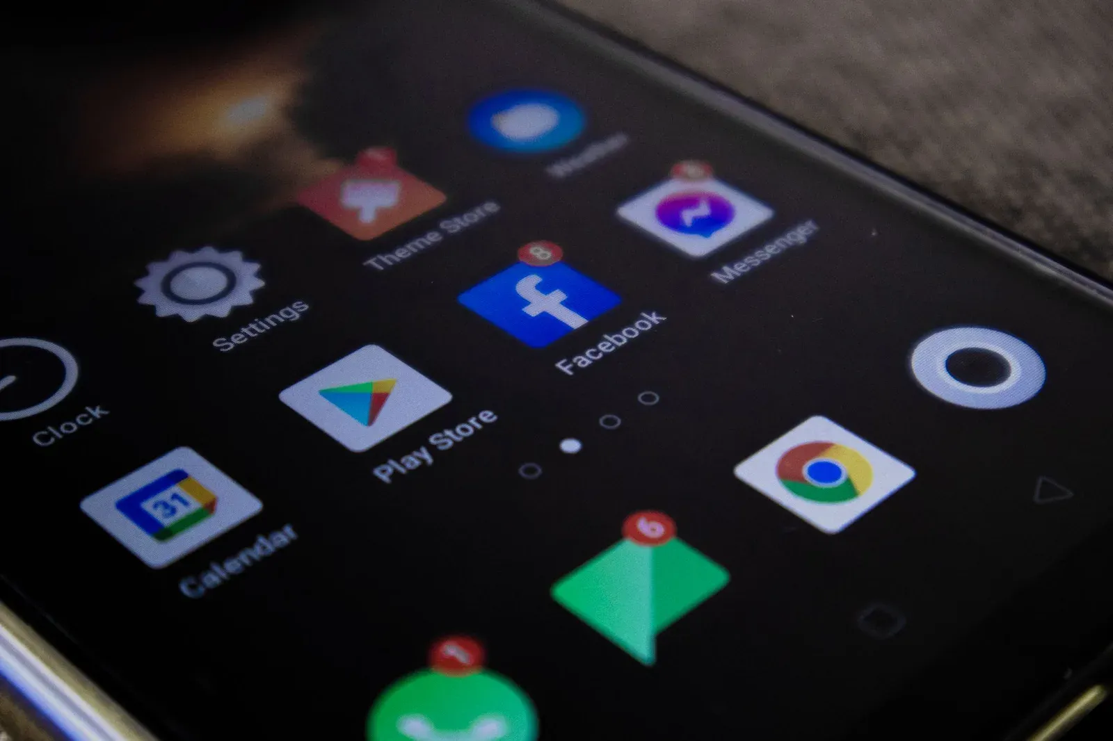 Detailed view of a smartphone screen with popular app icons including Facebook and Messenger.